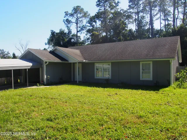 a house that has a tree in front of it