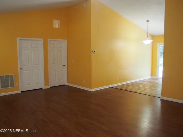 an empty room with wooden floor