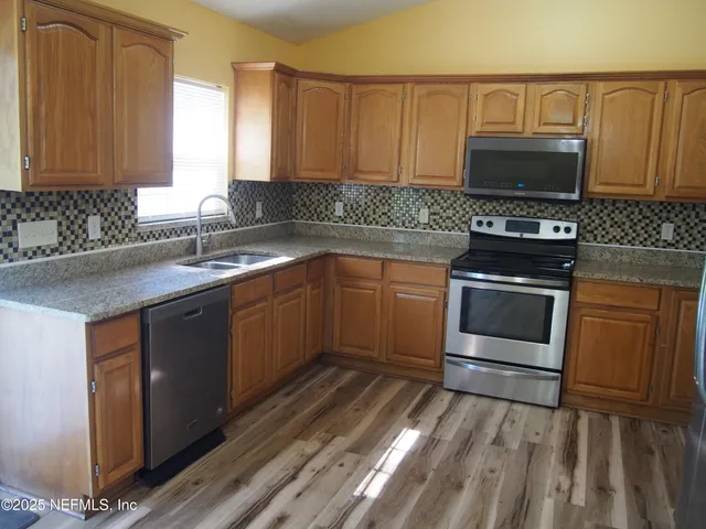 a kitchen with a sink stove and microwave
