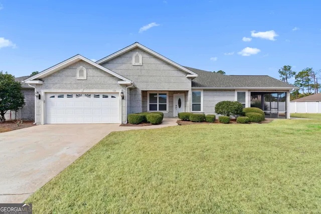 a front view of a house with a yard and garage
