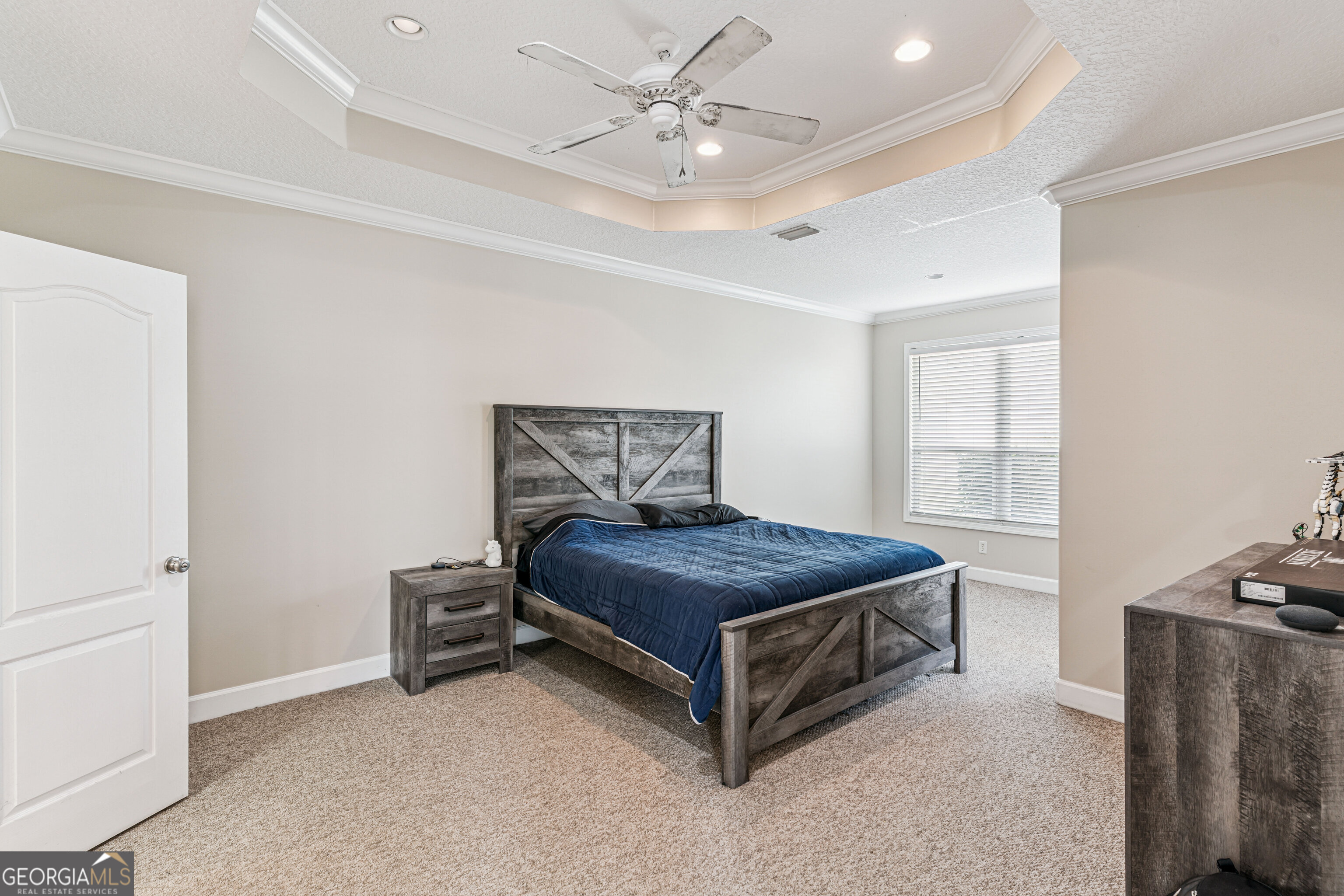 103 Meridian Drive Kingsland, GA 31548 - Photo 13 of 28 a bedroom with a bed and a ceiling fan