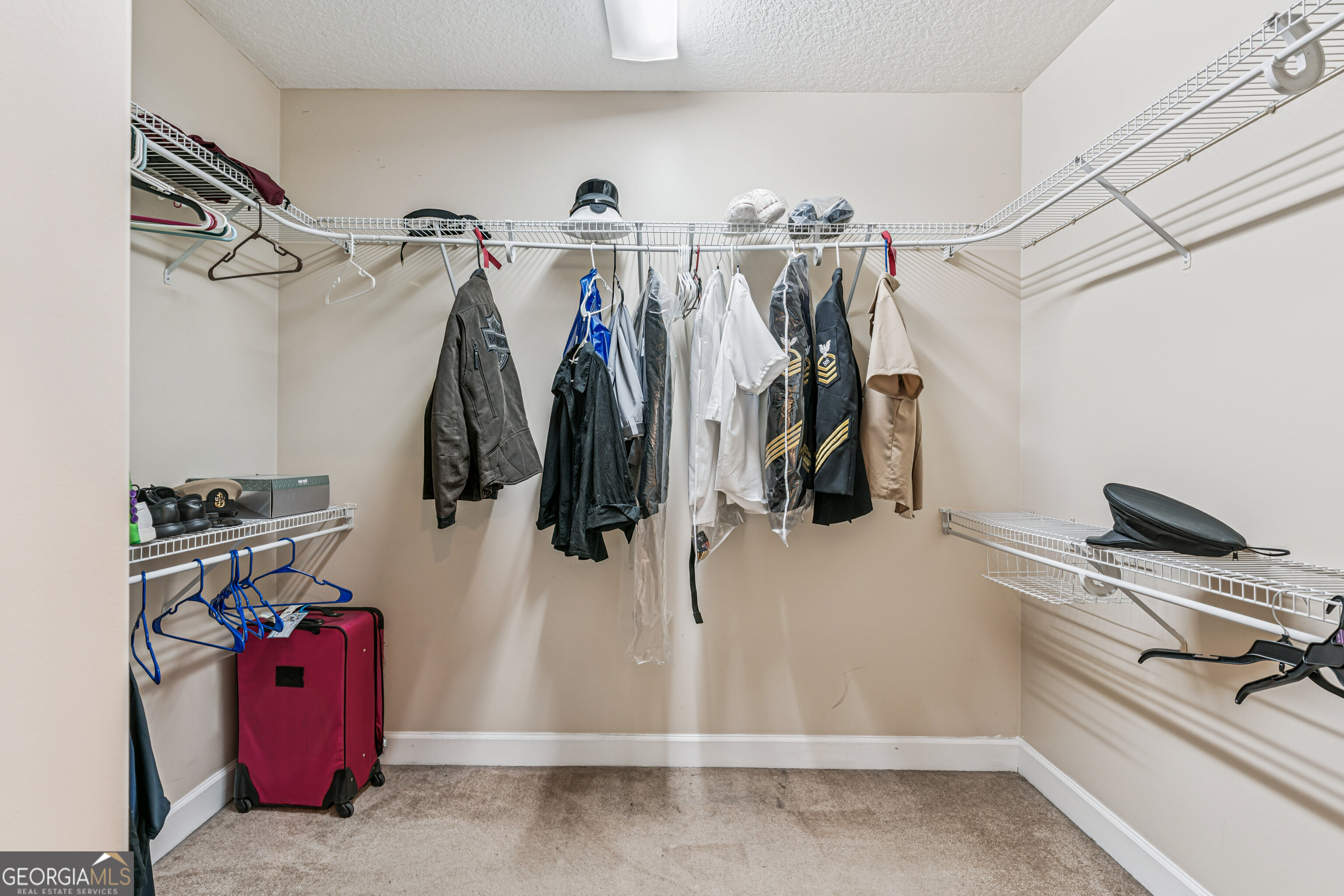 103 Meridian Drive Kingsland, GA 31548 - Photo 17 of 28 a view of walk in closet with clothes and shoes