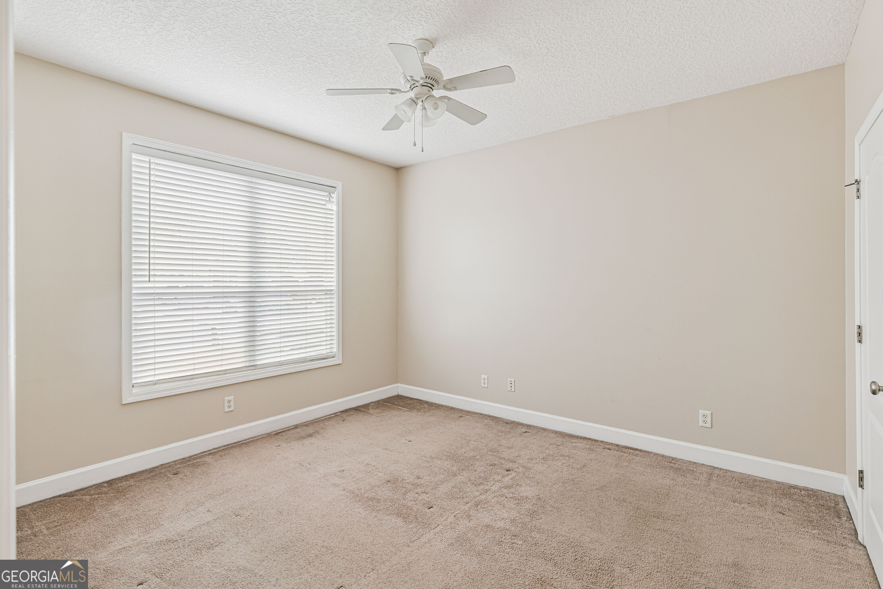 103 Meridian Drive Kingsland, GA 31548 - Photo 18 of 28 an empty room with a window and a ceiling fan