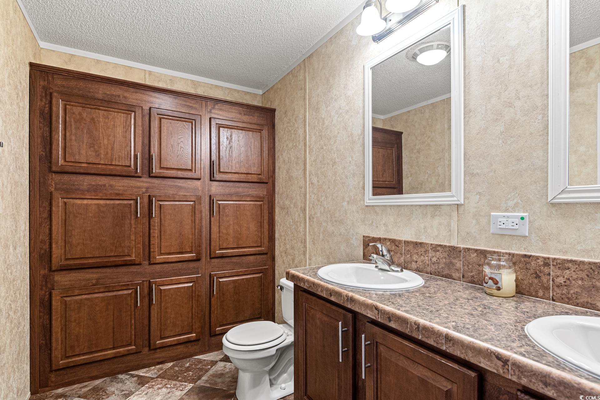 5148 Carriage Road Conway, SC 29527 - Photo 13 of 25 Bathroom with vanity, a textured ceiling, toilet,