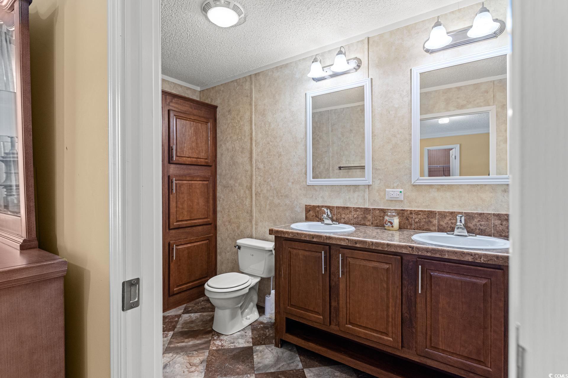 5148 Carriage Road Conway, SC 29527 - Photo 14 of 25 Bathroom with vanity, a textured ceiling, toilet,