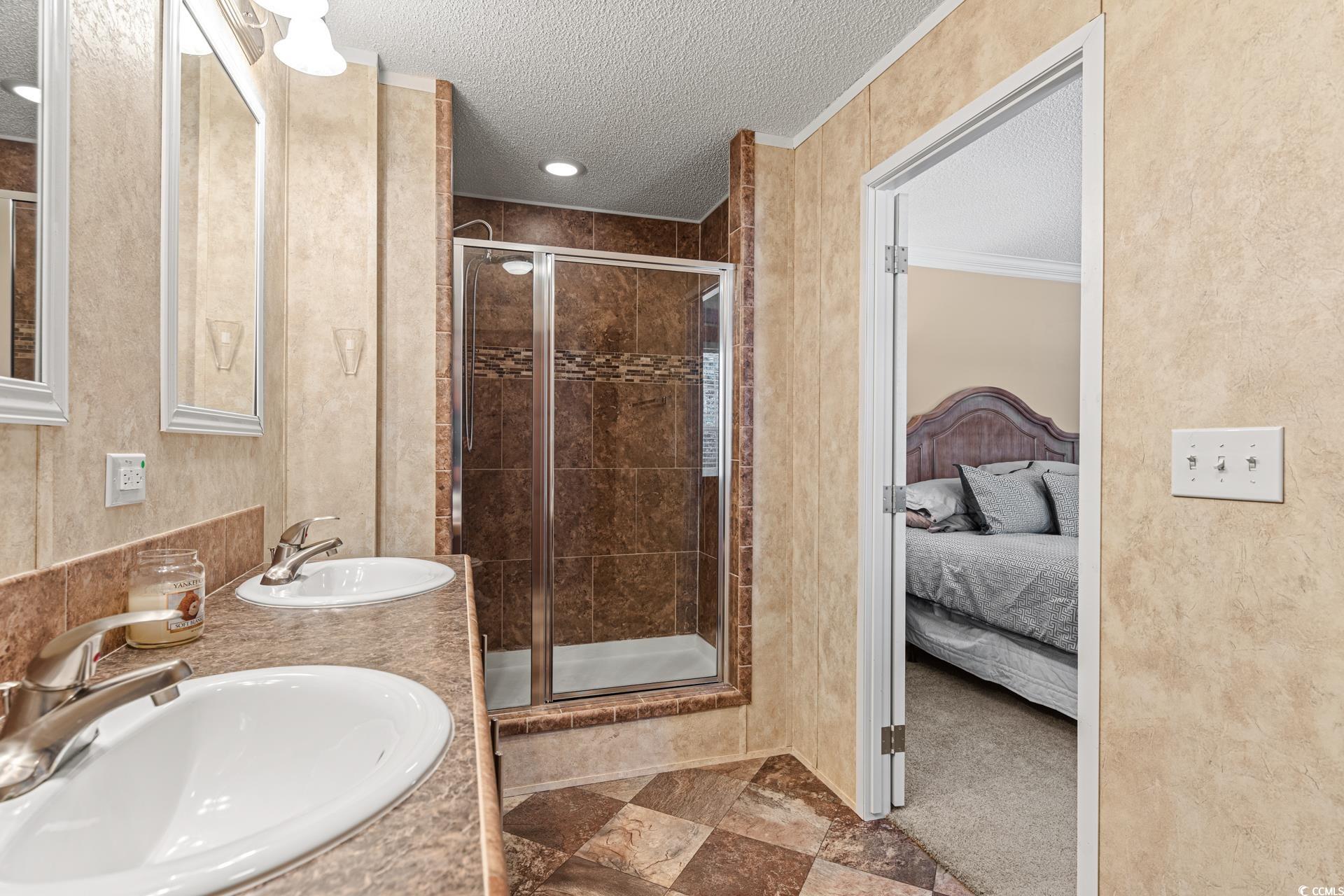 5148 Carriage Road Conway, SC 29527 - Photo 15 of 25 Bathroom featuring sink, an enclosed shower, and a