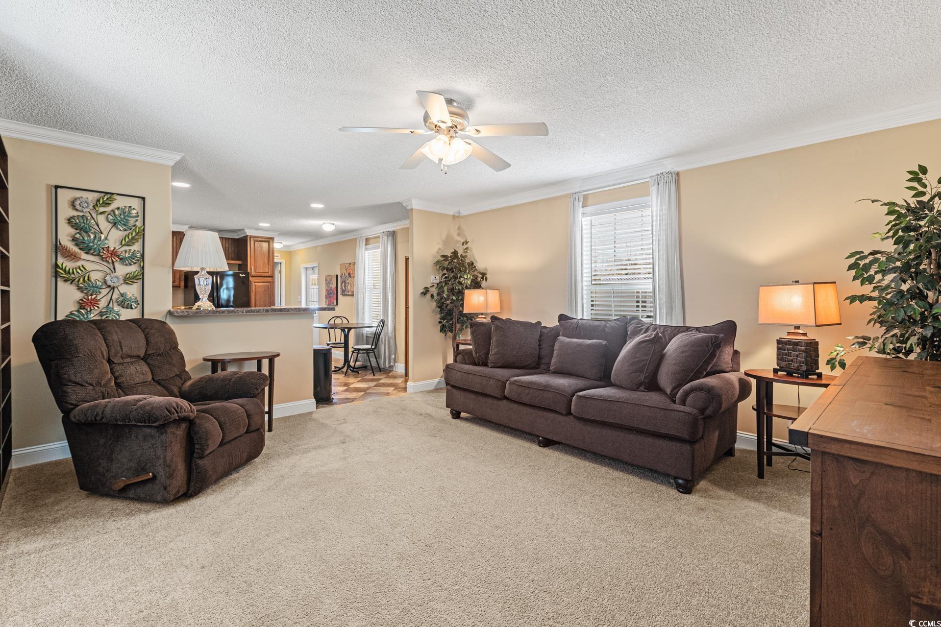 5148 Carriage Road Conway, SC 29527 - Photo 3 of 25 Carpeted living room featuring crown molding, ceil