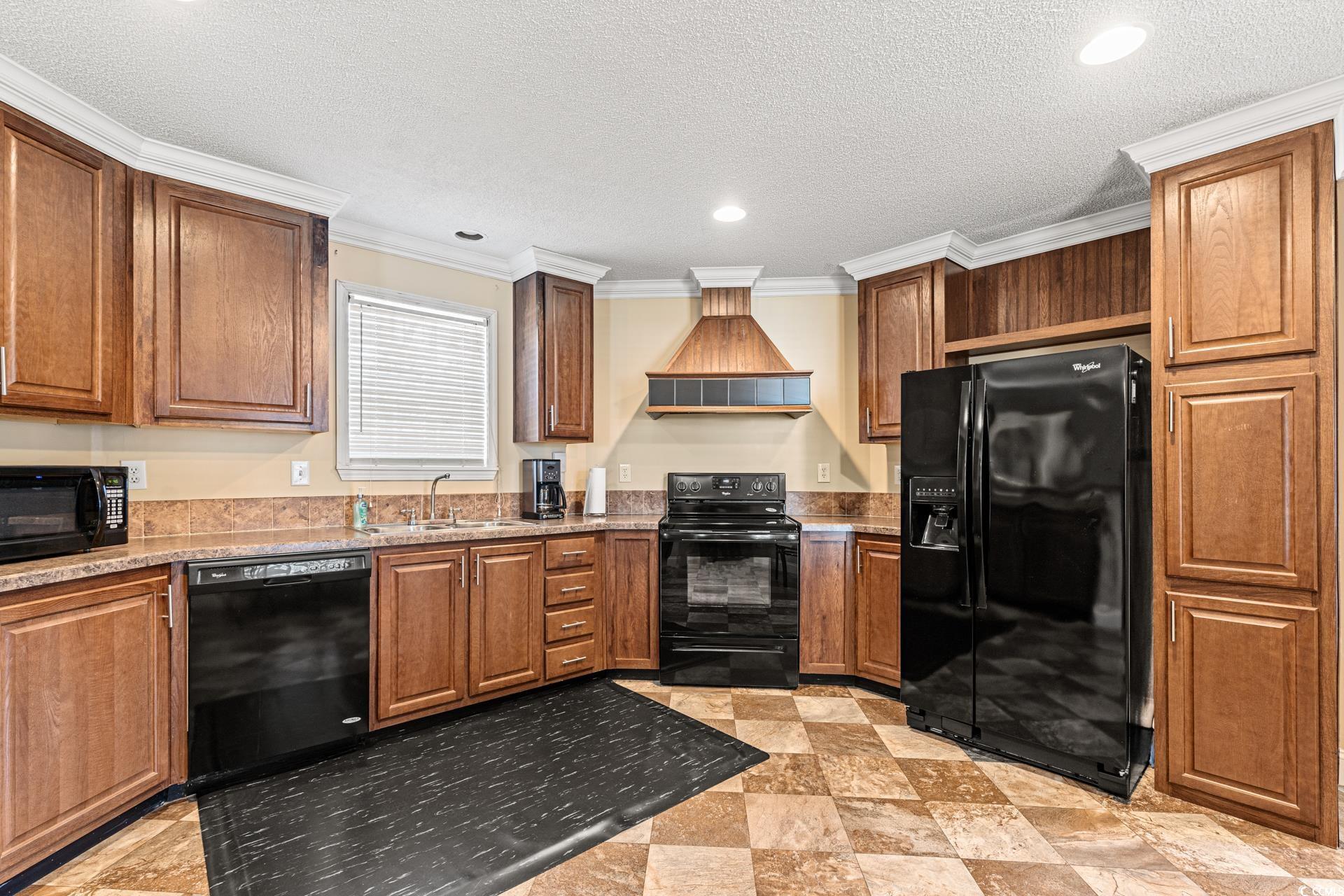 5148 Carriage Road Conway, SC 29527 - Photo 6 of 25 Kitchen with premium range hood, black appliances,