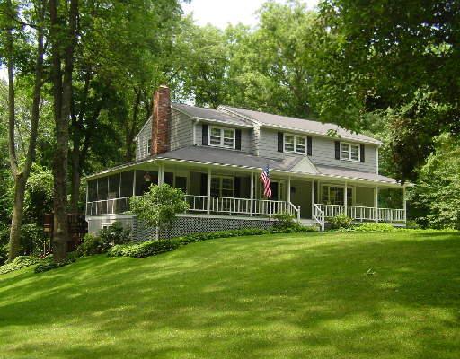 4 Fire Hill Lane Ridgefield, CT 06877 - Photo 1 of 1 a front view of a house with a yard table and chairs