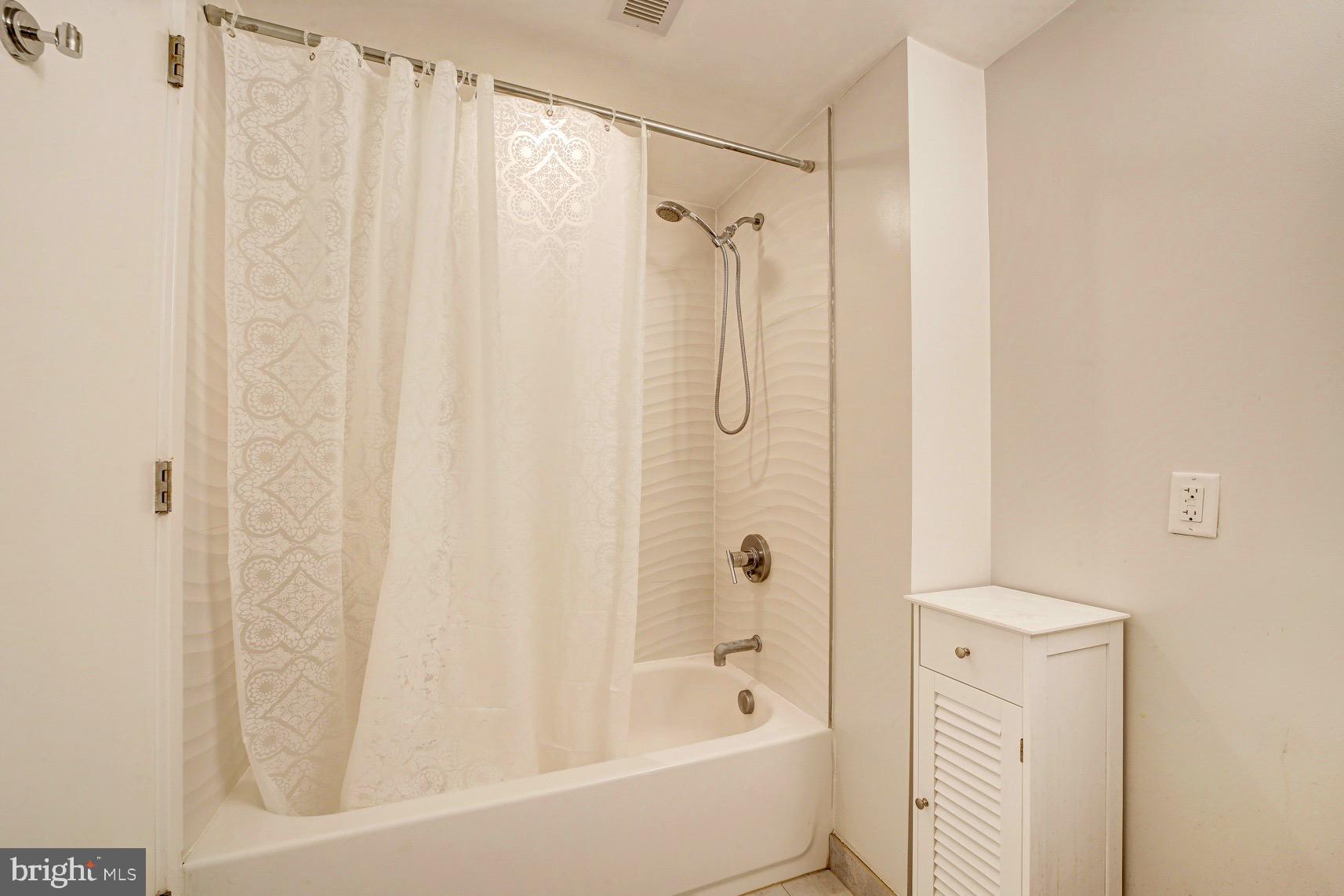 3511 13th Street Northwest, Unit 102 Washington, DC 20010 - Photo 11 of 23 a bathroom with a shower and a tub