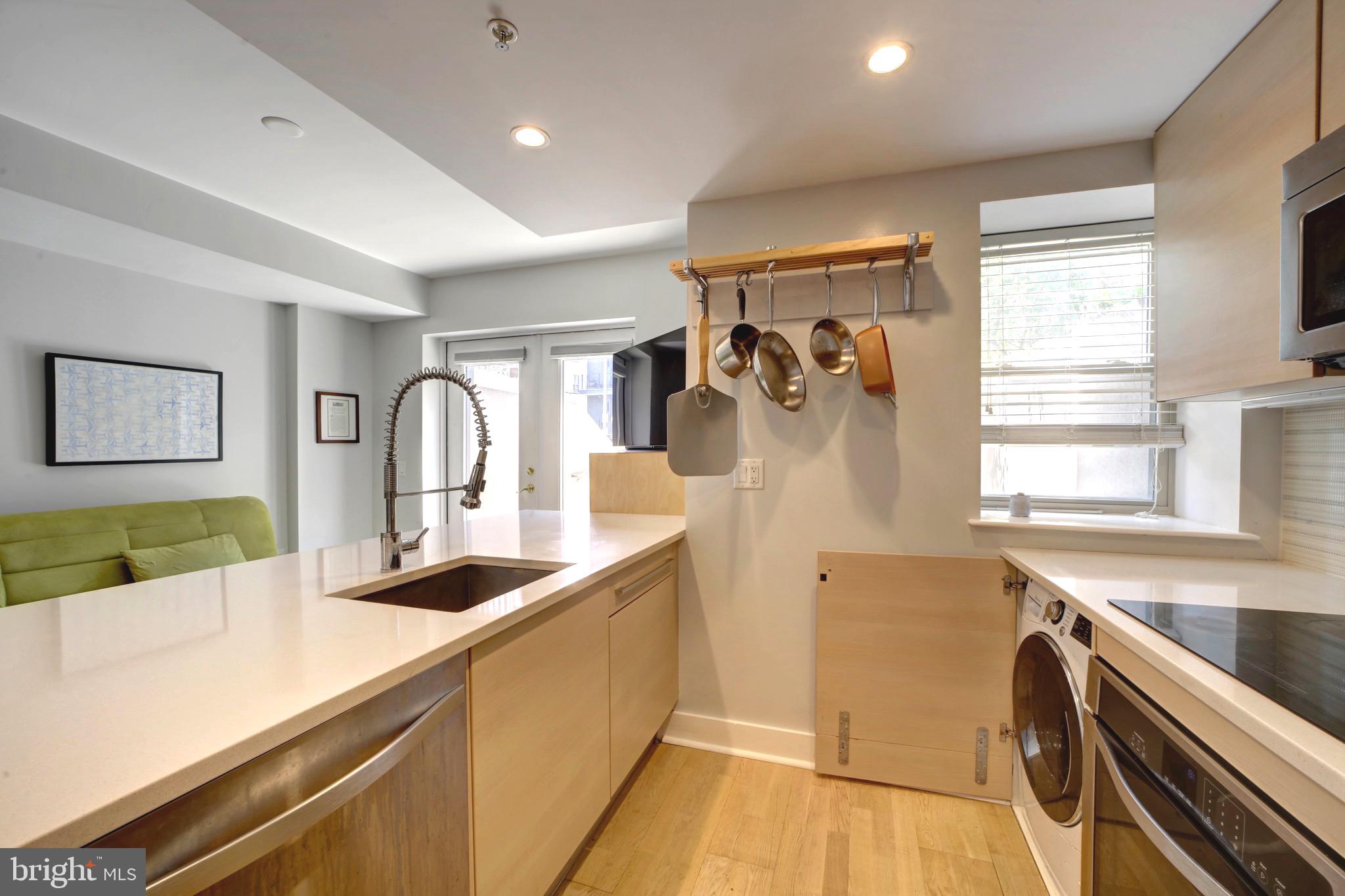 3511 13th Street Northwest, Unit 102 Washington, DC 20010 - Photo 3 of 23 a view of a kitchen with a sink and large windows