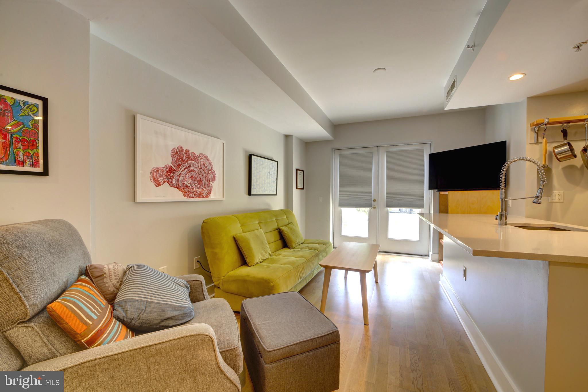 3511 13th Street Northwest, Unit 102 Washington, DC 20010 - Photo 5 of 23 a living room with furniture and a flat screen tv