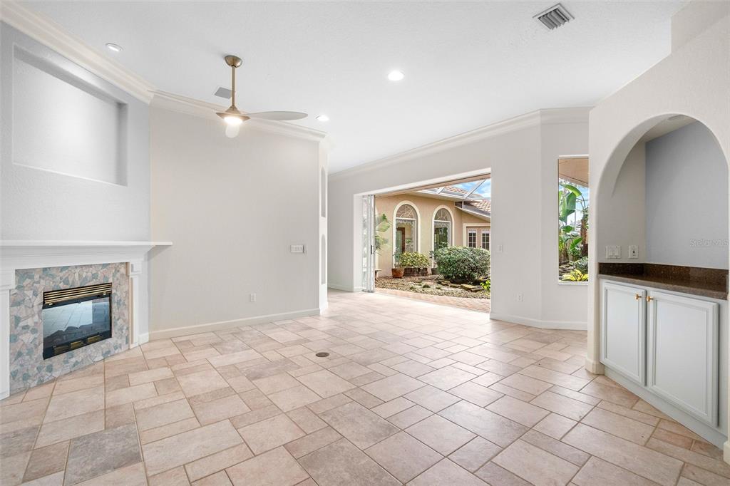 8356 Mareva Lane Sarasota, FL 34241 - Photo 11 of 44 an empty room with fireplace and windows