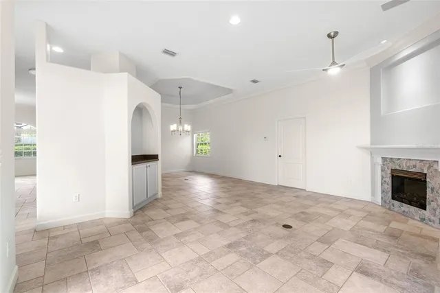 a view of a big room with chandelier and windows