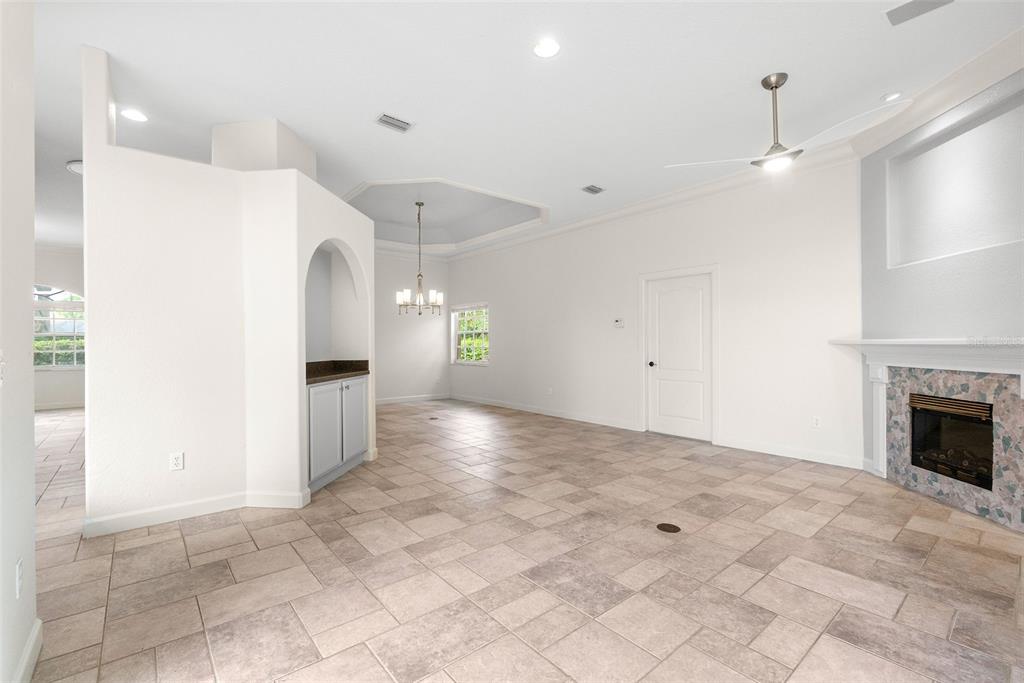 8356 Mareva Lane Sarasota, FL 34241 - Photo 12 of 44 an empty room with kitchen view and a fireplace