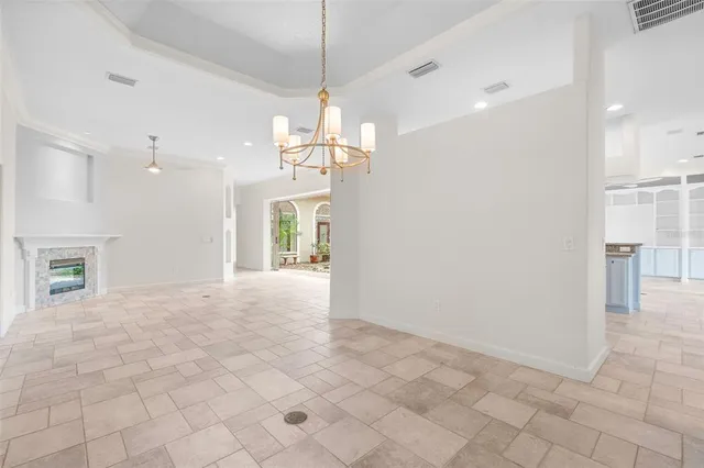 a view of entryway and hall with a chandelier fan