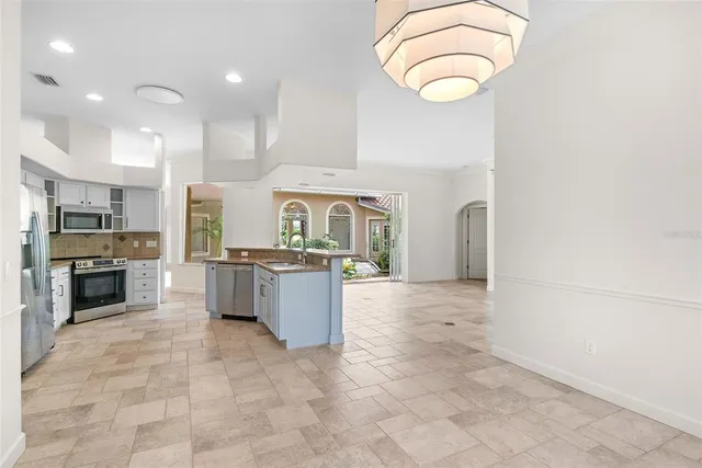 a view of a hallway with entryway to ceiling windows