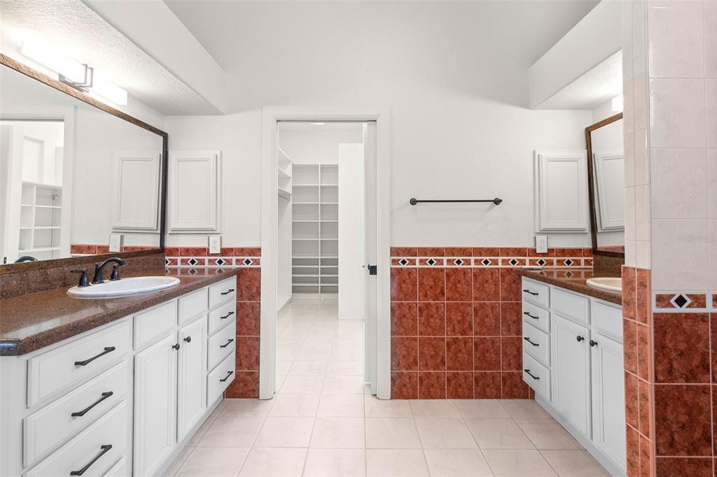 8356 Mareva Lane Sarasota, FL 34241 - Photo 29 of 44 a spacious bathroom with a double vanity sink and a mirror