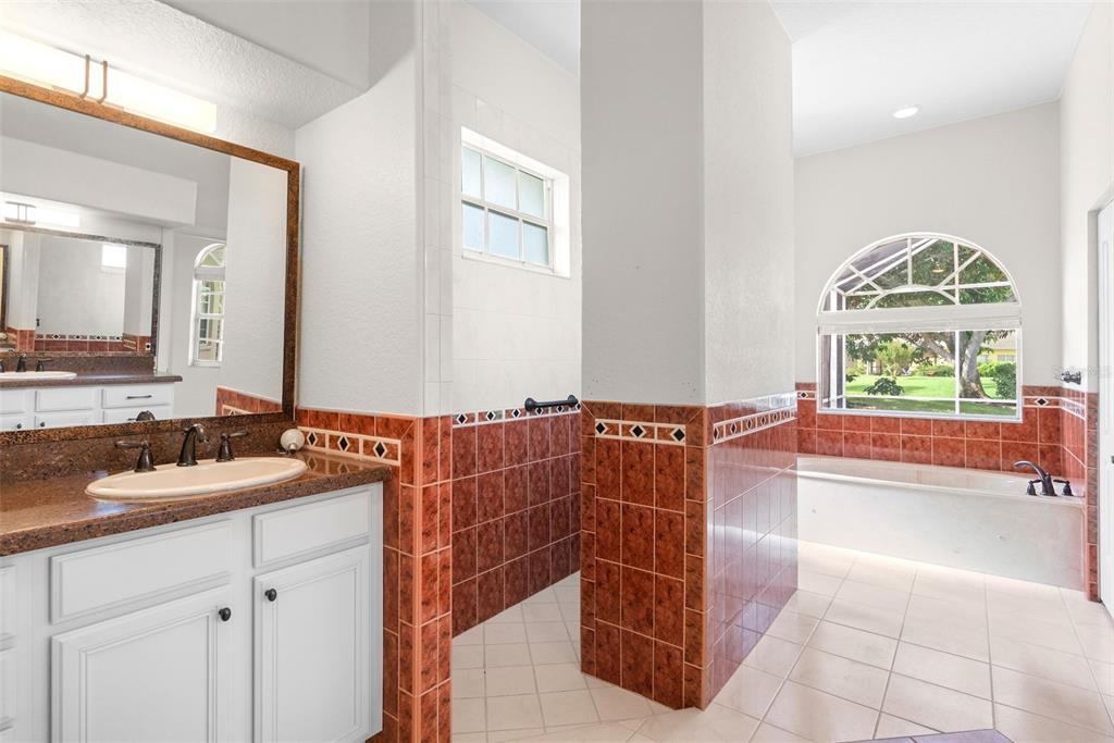 8356 Mareva Lane Sarasota, FL 34241 - Photo 30 of 44 a bathroom with a tub sink and mirror
