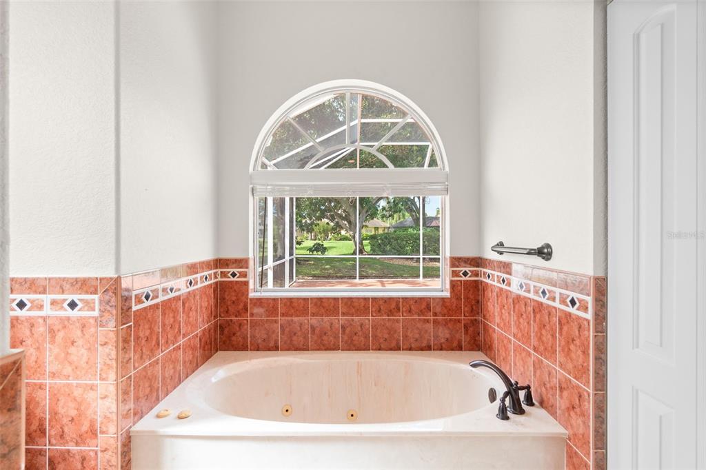 8356 Mareva Lane Sarasota, FL 34241 - Photo 31 of 44 a bathroom with a bathtub and a window