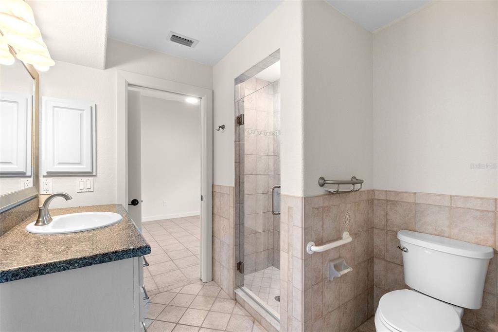 8356 Mareva Lane Sarasota, FL 34241 - Photo 36 of 44 a bathroom with a granite countertop sink toilet and shower