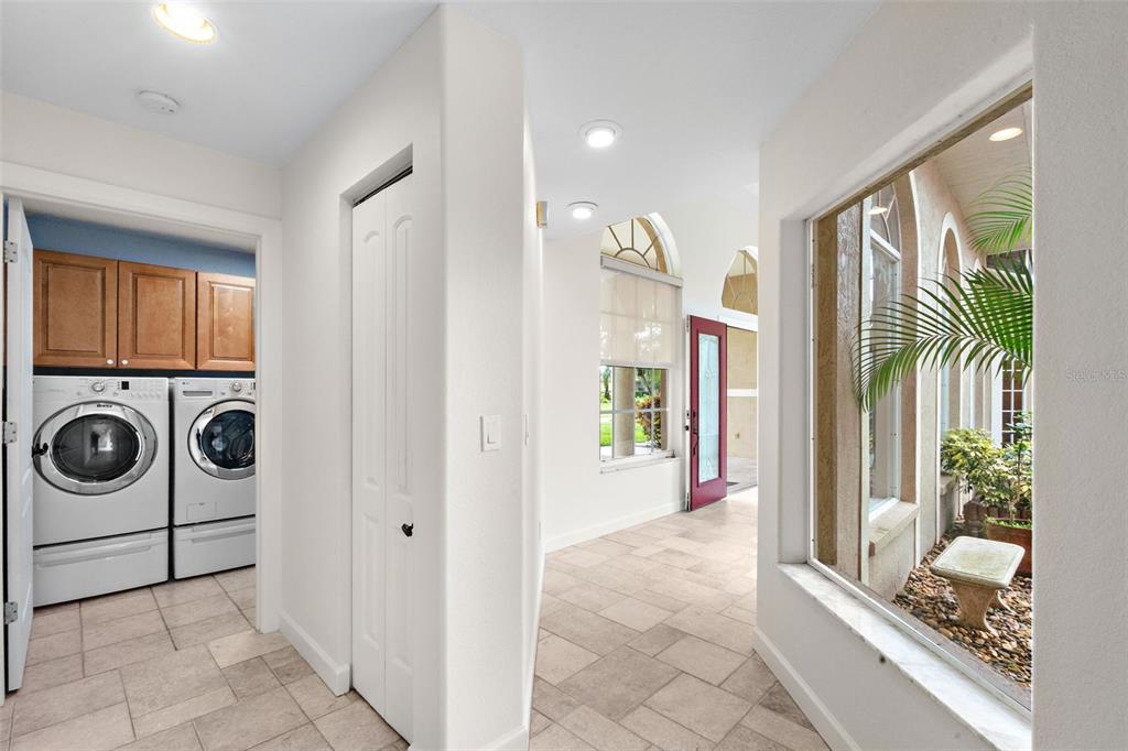 8356 Mareva Lane Sarasota, FL 34241 - Photo 40 of 44 a view of a hallway with washer and dryer