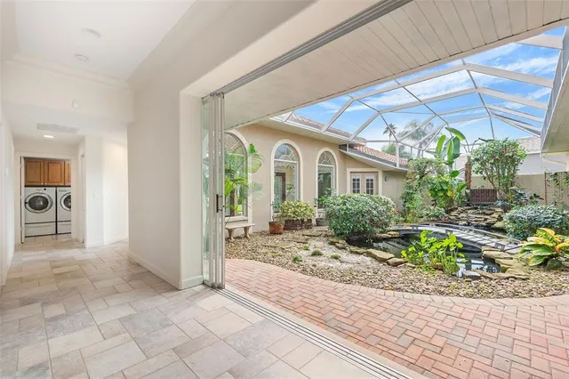 a view of a house with porch and garden