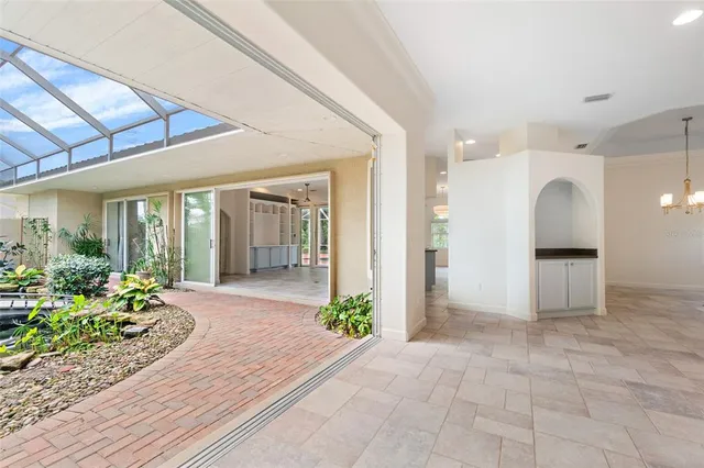 an empty room with fireplace and windows
