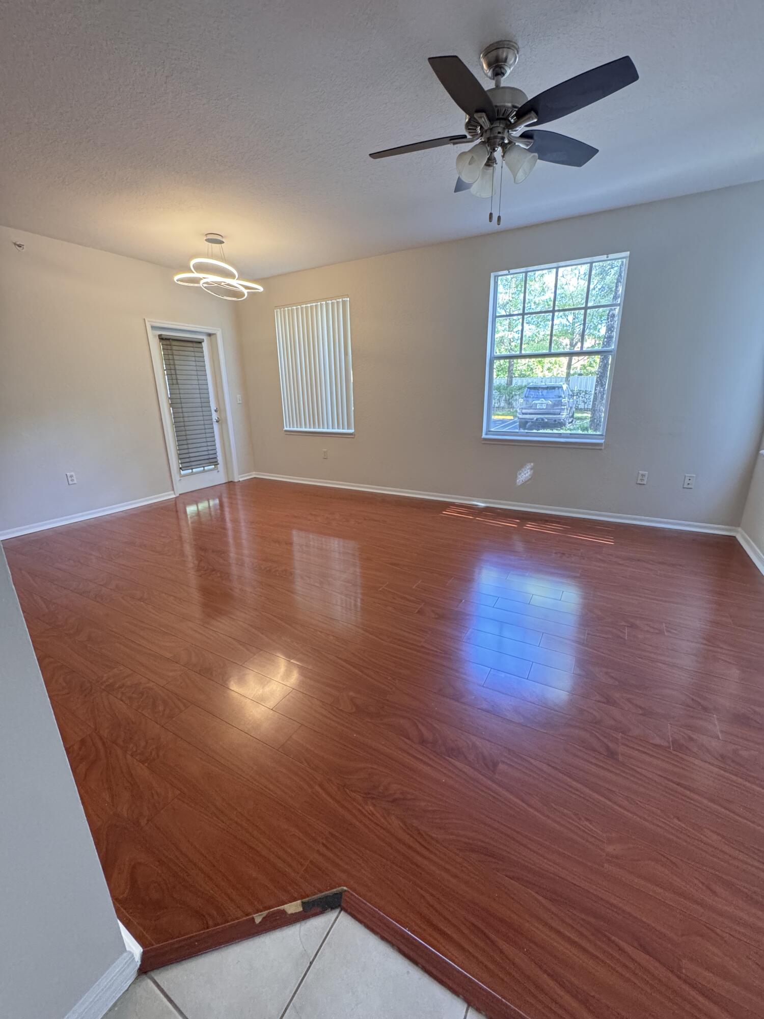6906 West Sample Road, Unit 6906 Pompano Beach, FL 33063 - Photo 2 of 10 wooden floor in an empty room with a window