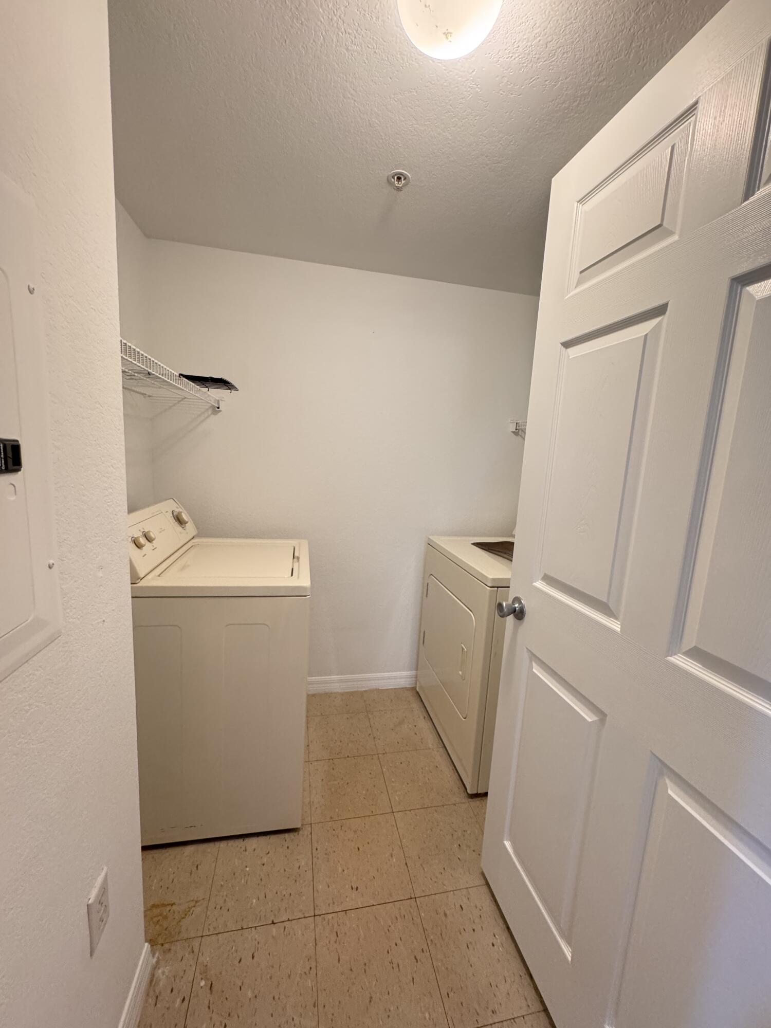 6906 West Sample Road, Unit 6906 Pompano Beach, FL 33063 - Photo 5 of 10 a utility room with dryer and washer