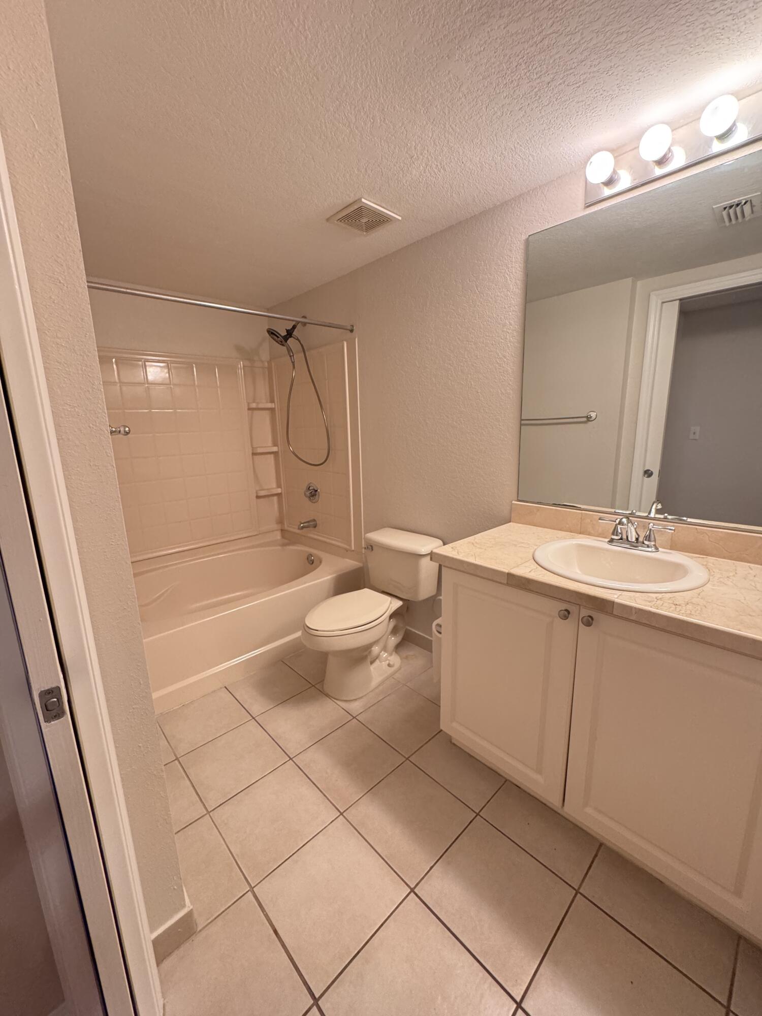 6906 West Sample Road, Unit 6906 Pompano Beach, FL 33063 - Photo 7 of 10 a bathroom with a sink a toilet and shower