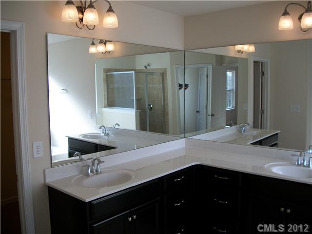 1240 Screech Owl Road Waxhaw, NC 28173 - Photo 8 of 14 a bathroom with double vanity and a mirror