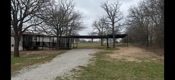 a view of house with a back yard