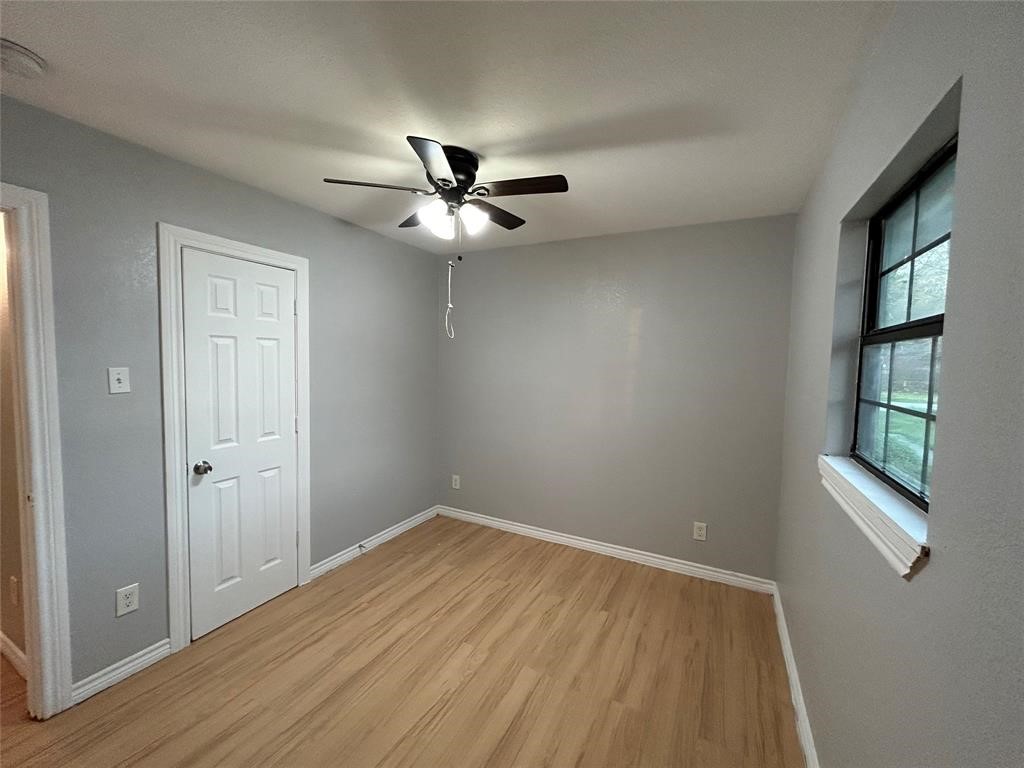 6818 Weston Street, Unit 1 Houston, TX 77021 - Photo 6 of 10 wooden floor in an empty room with a window