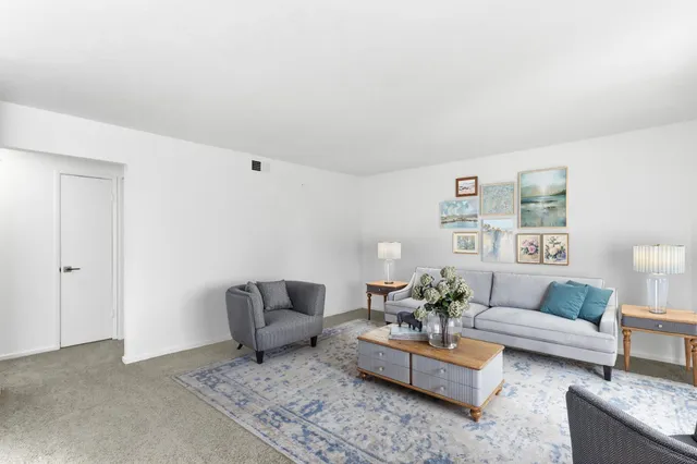 a living room with furniture and a rug
