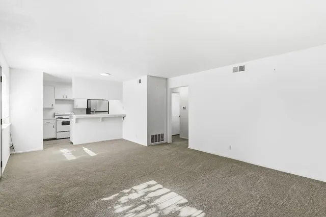 a kitchen with white cabinets and white appliances