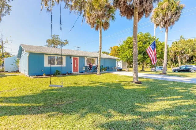 a swimming pool with outdoor seating and yard