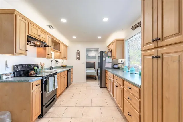 a kitchen with stainless steel appliances granite countertop a sink and cabinets