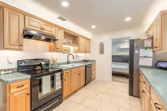 a kitchen with stainless steel appliances granite countertop a stove and a sink