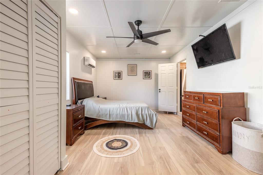 1804 Mango Tree Drive Edgewater, FL 32132 - Photo 14 of 43 a bedroom with a bed and flat screen tv