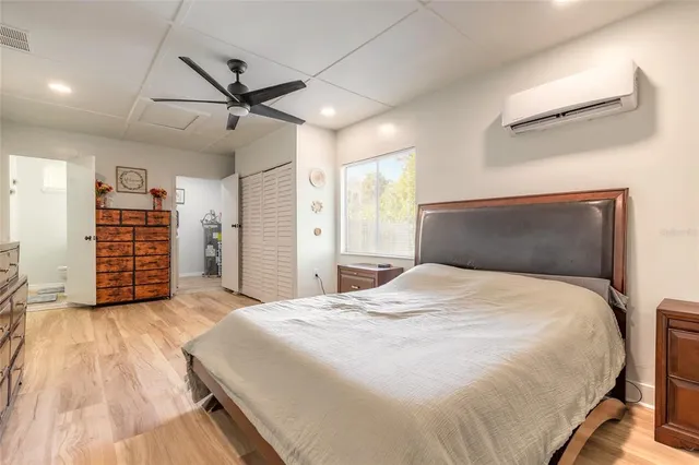 a bedroom with a large bed and a flat tv screen