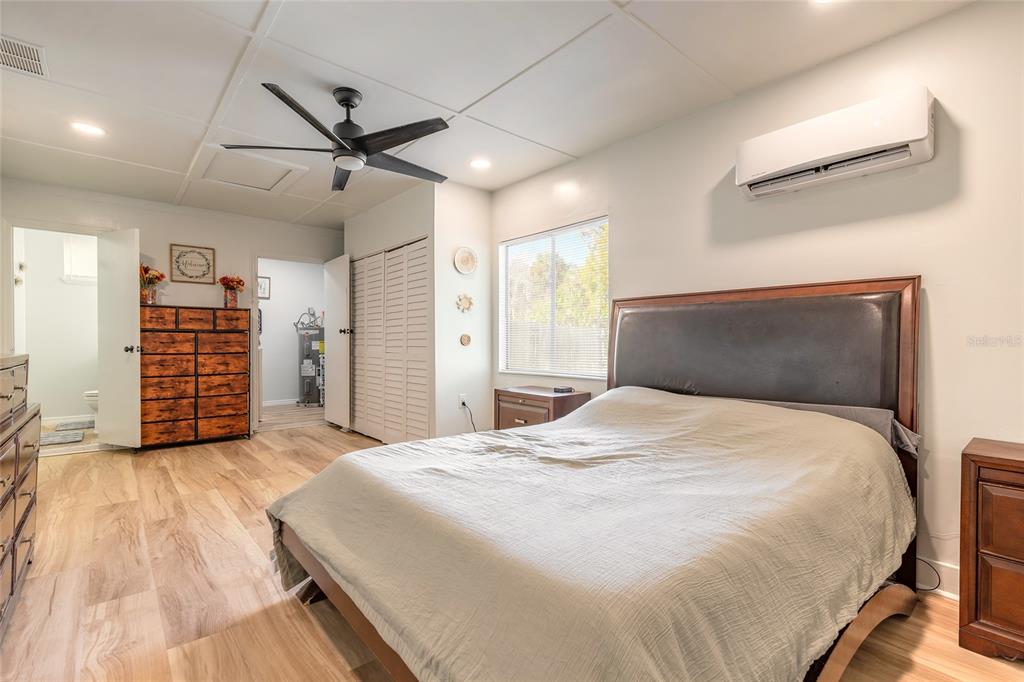 1804 Mango Tree Drive Edgewater, FL 32132 - Photo 16 of 43 a bedroom with a large bed and a flat tv screen