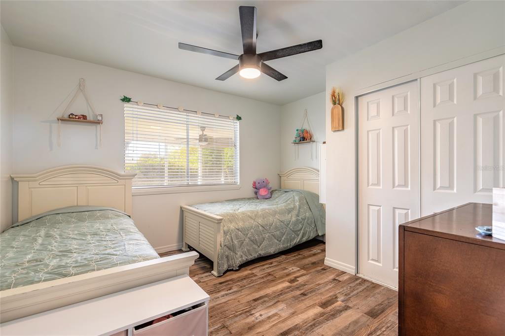 1804 Mango Tree Drive Edgewater, FL 32132 - Photo 20 of 43 a bedroom with two beds and a chandelier