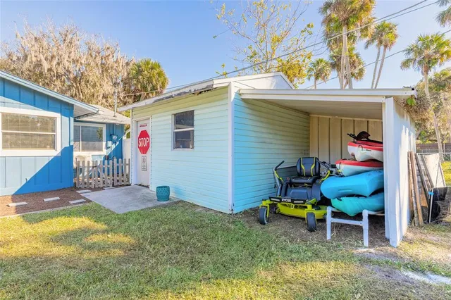 a backyard of a house with table and chairs