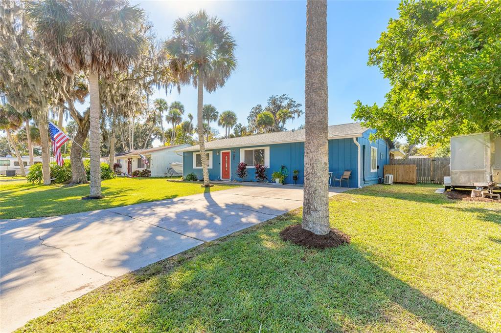 1804 Mango Tree Drive Edgewater, FL 32132 - Photo 33 of 43 a view of a house with swimming pool next to a yard