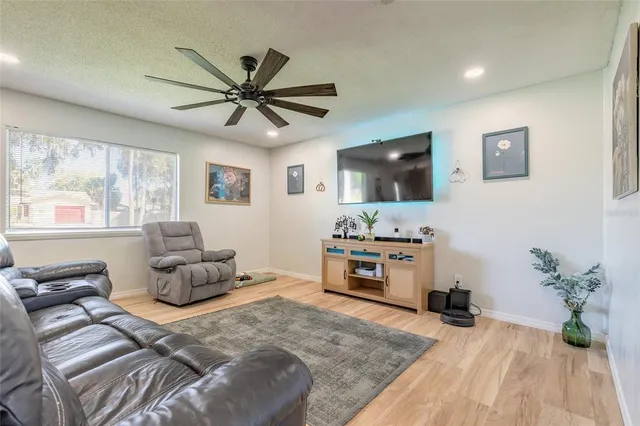 a bedroom with furniture and a flat screen tv