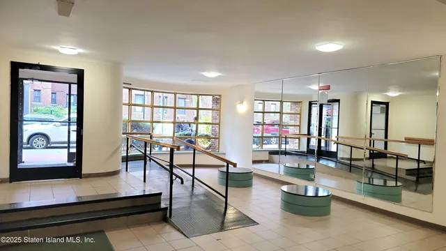 a lobby with furniture and floor to ceiling window