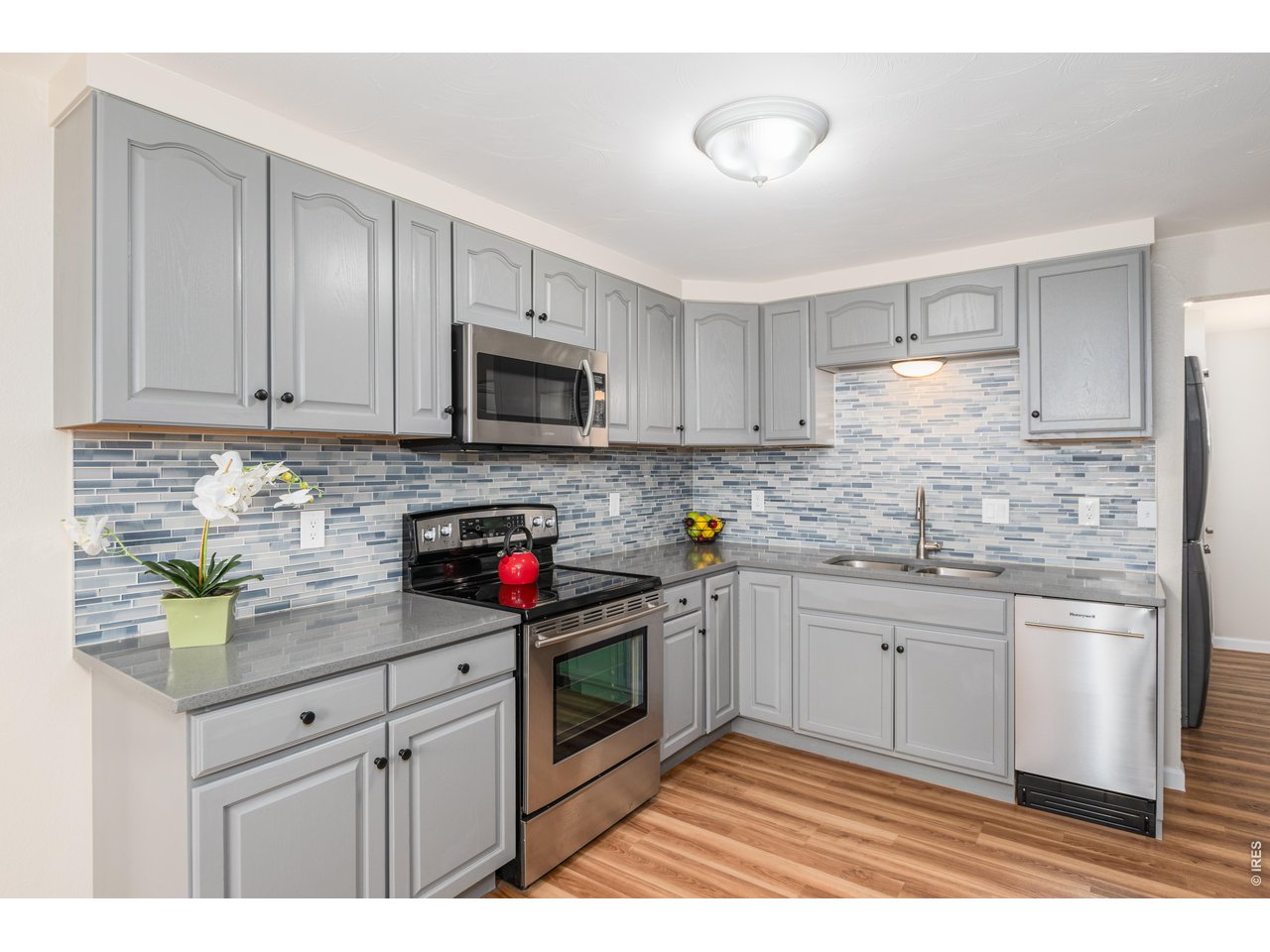 439 Dickson Street Longmont, CO 80504 - Photo 12 of 31 a kitchen with stainless steel appliances granite countertop a sink and cabinets