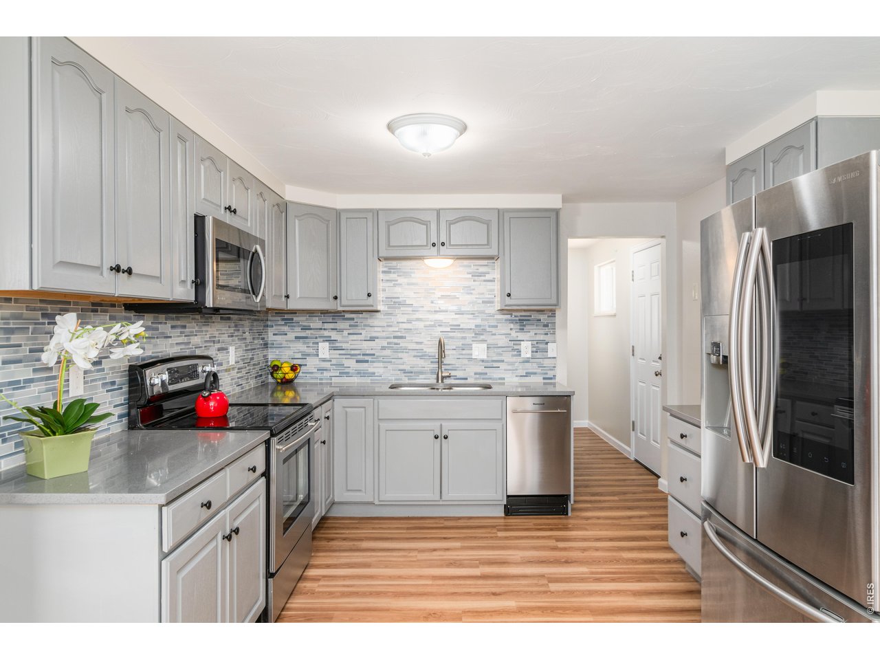 439 Dickson Street Longmont, CO 80504 - Photo 13 of 31 a kitchen with stainless steel appliances granite countertop a refrigerator sink and stove