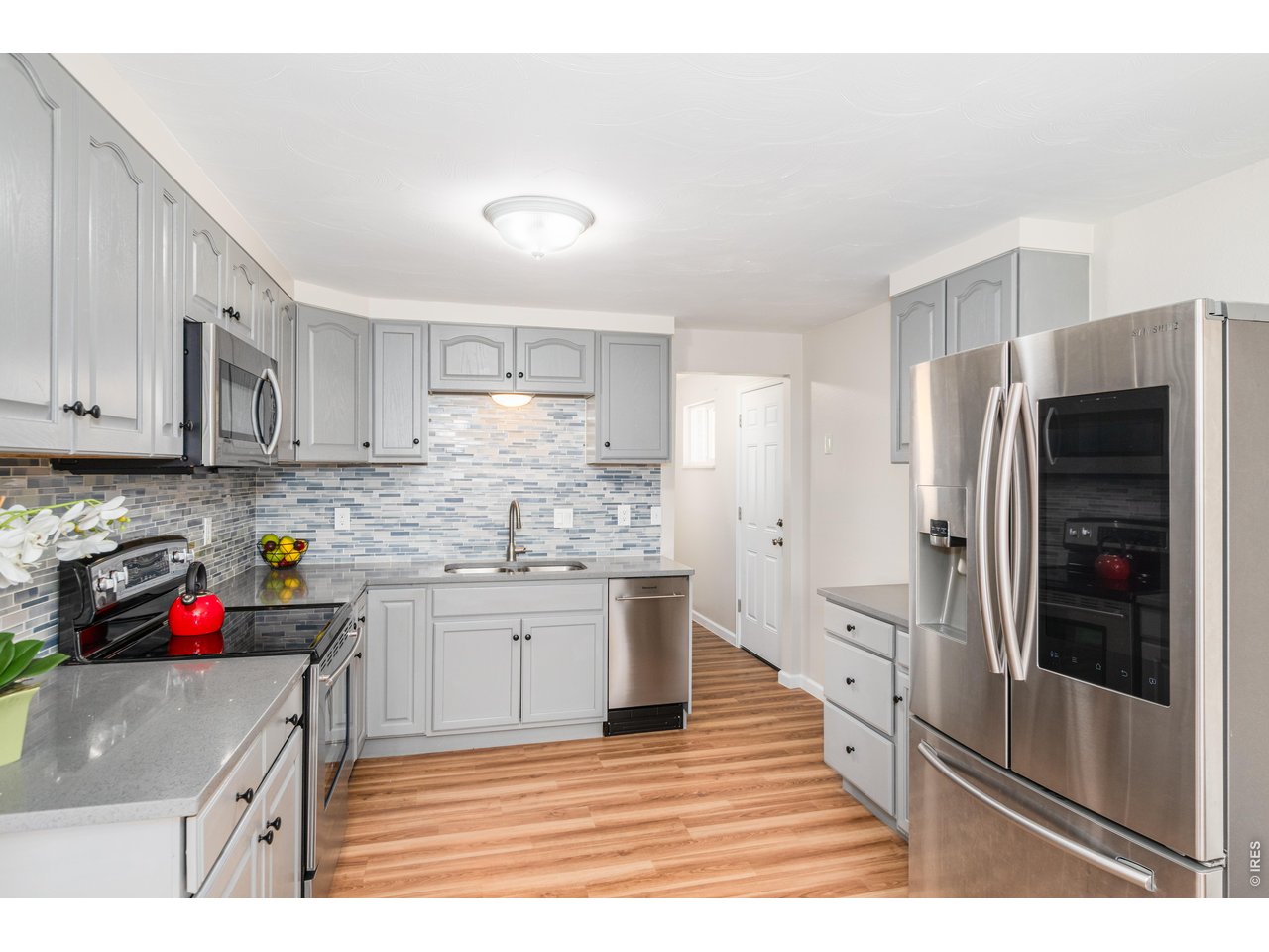 439 Dickson Street Longmont, CO 80504 - Photo 14 of 31 a kitchen with stainless steel appliances granite countertop a refrigerator and a stove top oven